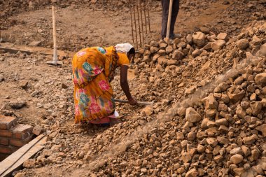 MUMBAI, MAHARASHTRA, INDIA 19 DECEMBER 2019 : Construction workers working on a building development site. In India building workers are not wear any safety measures at work.