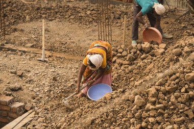 MUMBAI, MAHARASHTRA, INDIA 19 DECEMBER 2019 : Construction workers working on a building development site. In India building workers are not wear any safety measures at work.
