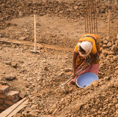 MUMBAI, MAHARASHTRA, INDIA 19 DECEMBER 2019 : Construction workers working on a building development site. In India building workers are not wear any safety measures at work.