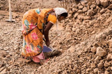 MUMBAI, MAHARASHTRA, INDIA 19 DECEMBER 2019 : Construction workers working on a building development site. In India building workers are not wear any safety measures at work.