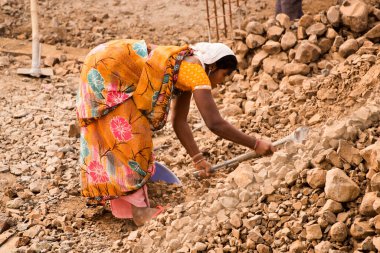 MUMBAI, MAHARASHTRA, INDIA 19 DECEMBER 2019 : Construction workers working on a building development site. In India building workers are not wear any safety measures at work.