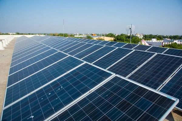 Photovoltaic solar panels on building roof, Regenerative energy system electricity generation, Maharashtra, India.