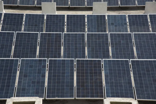 Photovoltaic solar panels on building roof, Regenerative energy system electricity generation, Maharashtra, India.