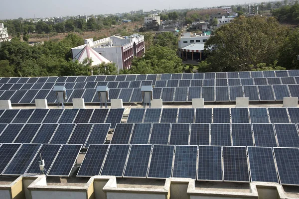 Photovoltaic solar panels on building roof, Regenerative energy system electricity generation, Maharashtra, India.