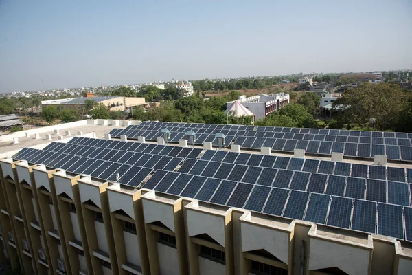 Photovoltaic solar panels on building roof, Regenerative energy system electricity generation, Maharashtra, India.