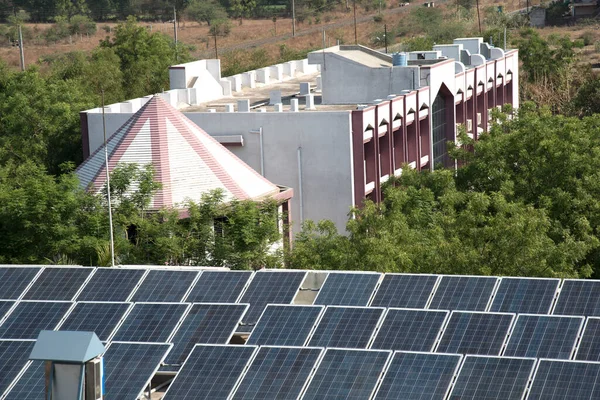 Photovoltaic solar panels on building roof, Regenerative energy system electricity generation, Maharashtra, India.