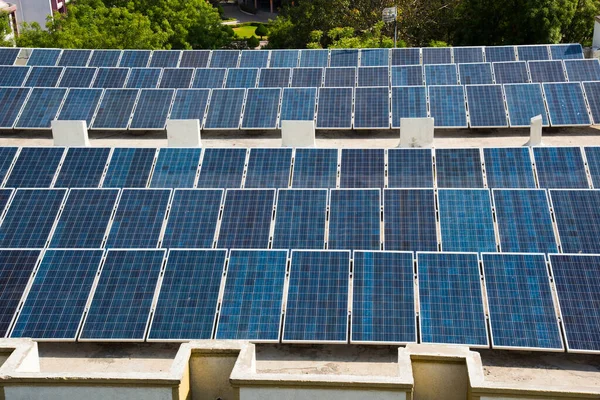 Photovoltaic solar panels on building roof, Regenerative energy system electricity generation, Maharashtra, India.