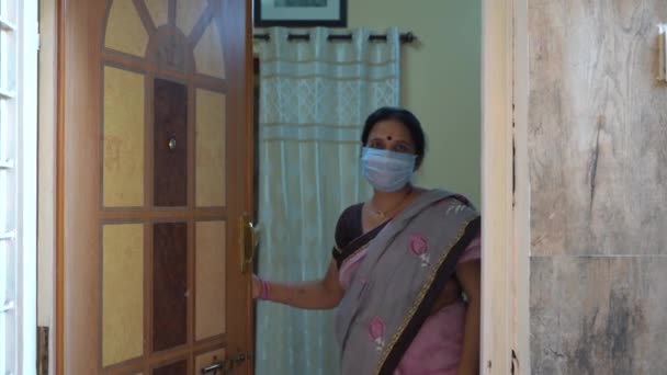 Kobieta Objęta Kwarantanną Masce Otwierająca Drzwi Podczas Pandemii Koronawirusa Pandemii — Wideo stockowe