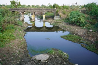 Dirty waste dark black stinking unpleasant odor of water from city.