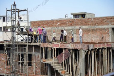 AMRAVATI, MAHARASHTRA, INDIA 9 JUNE 2020 : Construction workers working on a building development site.