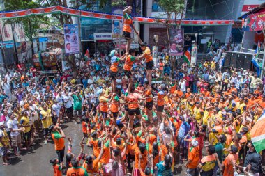 MUMBAI, MAHARASHTRA, INDIA 3 Eylül 2018: İnsan kulesi inşa eden ve Tanrı Krishna 'nın Mumbai caddesinde doğumunu kutlamak için Dahi Handi Festivali' nin tadını çıkaran genç kalabalık.