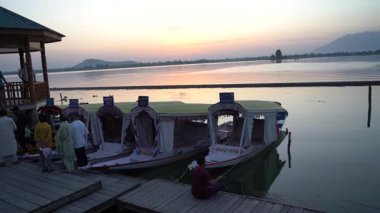 SRINAGAR, KASHMIR, INDIA, July 15, 2024 : People fishing in The Dal Lake, For most of local dwellers fishing with a rod just a hobby