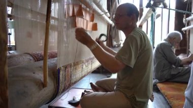 SRINAGAR, INDIA, 28 HAZİRAN 2024 Kashmiri adam elle dokuma makinesi ile bir halı örüyor, Kaşmir halısı dünyada meşhurdur.
