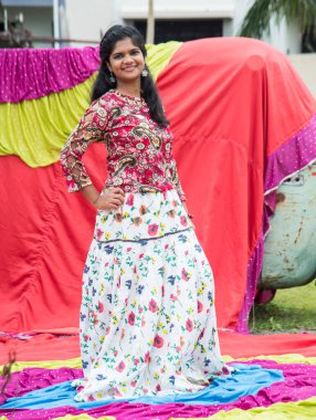 Renkli perdelerin önünde güzel bir Hintli kız.