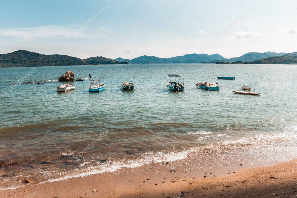 Travel Shot of Caribbean Setting of Peng Chau Island Sandy Beach with Turquoise Blue Water and Fishing Boats, Hong Kong