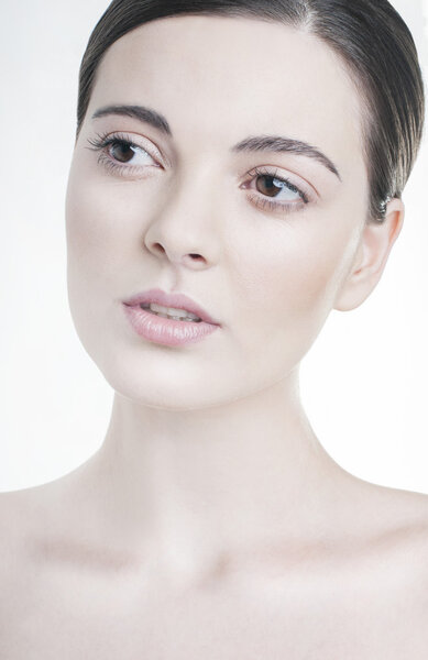 Beauty portrait. Young woman with natural make up.  Studio shot on white background