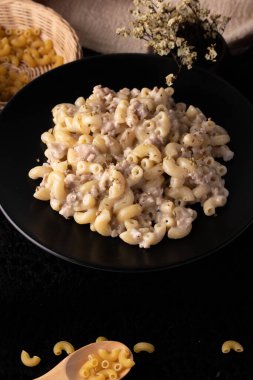 Carbonara soslu ve siyah tabaklı makarna.