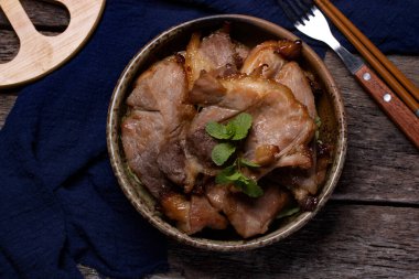 Ahşap zeminde seramik bir fincanda domuz rostosu.