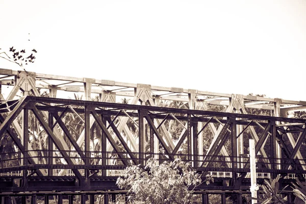 Bridge over the railroad, made of steel, old photo, vintage style.