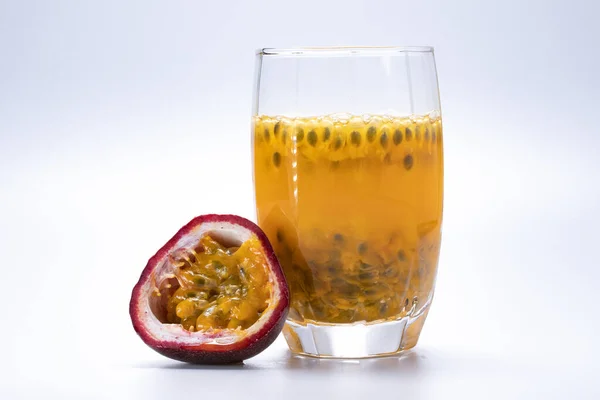 Passion fruit juice in a clear glass and fruit of passion fruit