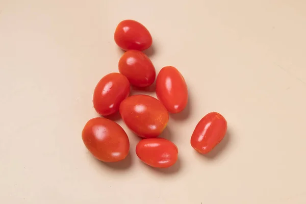 Fresh cherry tomatoes on brown background