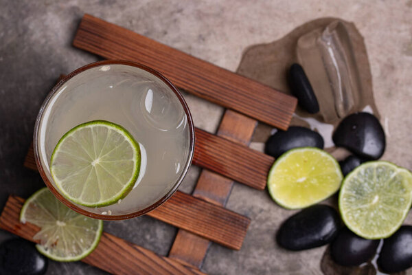 Refreshing lemonade in a clear glass decorated with fresh lemon.