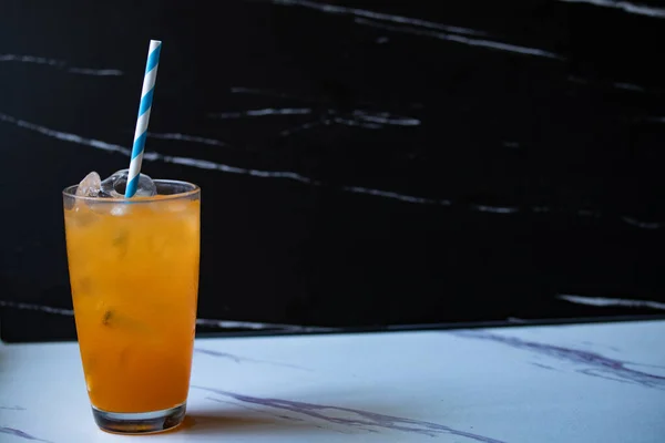 黒の背景に透明なガラスのオレンジジュースコピースペース — ストック写真