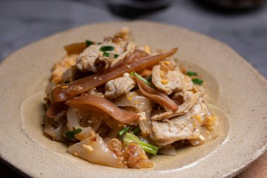 Kızarmış pirinçli erişteyi tavukla karıştır.