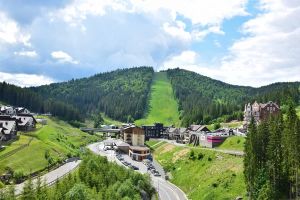 Ski resort in summer aerial view, in the background a lift to the mountain