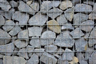 A large fence of many stone cobblestones supported by a stone trellis for the entire frame. The design takes up the entire background