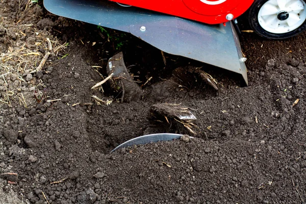 Man Farmer membajak tanah dengan kultivator. Pertanian mesin: budidaya untuk pengolahan di kebun, motor kultivator. — Stok Foto