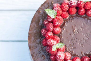 Beyaz arka planda ahududulu çikolatalı pasta..