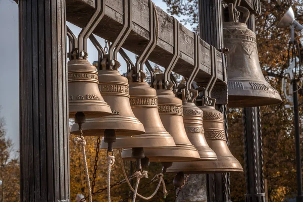 Old bronze bells of the Church of the Sign of the Blessed Virgin Mary in Dubrovitsy village on an autumn day. Religious architecture theme. Selective focus.
