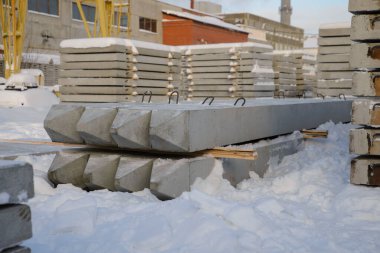 İnşaatın temelleri için güçlendirilmiş beton yığınları, elektrik hattı destekleri. Önceden hazırlanmış beton fabrikasının rafına yığın
