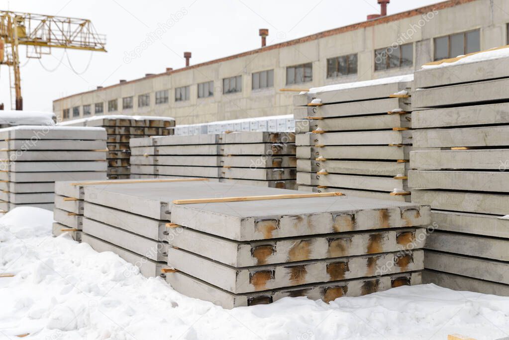 Reinforced concrete slabs intended for the construction of roads and airfields. Storage at the warehouse of the precast concrete plant.