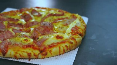 Sosis ve Jambonlu Peynirli Pizza. Teslimat kutusundaki pizza mermer masanın üstünde teslim edildi..