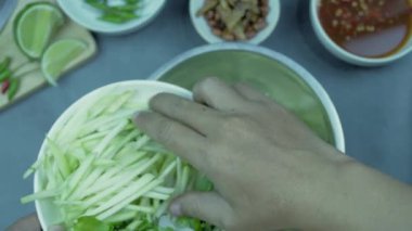 Yum mango görüntüler üst görünüm yiyecek düzenlemesi. Baharatlı salata yemeği, üzerine kızarmış fındık ve çıtır balık. Ana malzemeler çiğ mango, limon suyu, taze biber tozu, balık sosu, karıştırmak için şeker..