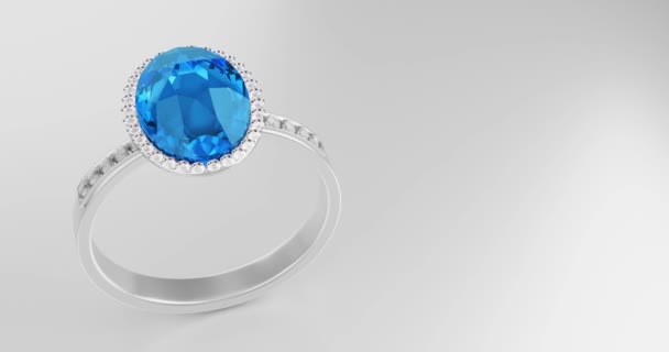 大きな青色のダイヤモンドの楕円形は グレーの背景に置かれたプラチナゴールド製のリングの上に多くのダイヤモンドに囲まれています 女性のためのエレガントな結婚指輪 3Dレンダリング — ストック動画