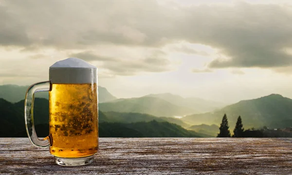 Bira bardağının içinde bira köpüğü ve ahşap masa ve sandalyelerin üzerinde bira bardağı. Ahşap terasta, dağ zemininde, Tanrı 'nın ışığıyla ya da 33d güneş ışığıyla oturma odası.