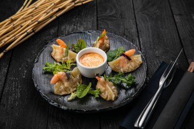 Japon restoranındaki karanlık bir masada Japon mantısı.