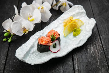 Japonlar beyaz tabakta yuvarlanıyor. Japon mutfağı.