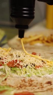 A chef makes shawarma in a caf.  Close-ups.