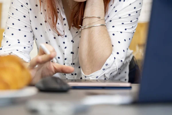 woman draws with a stylus on a tablet. female hands work on a tablet computer. creative profession.no face