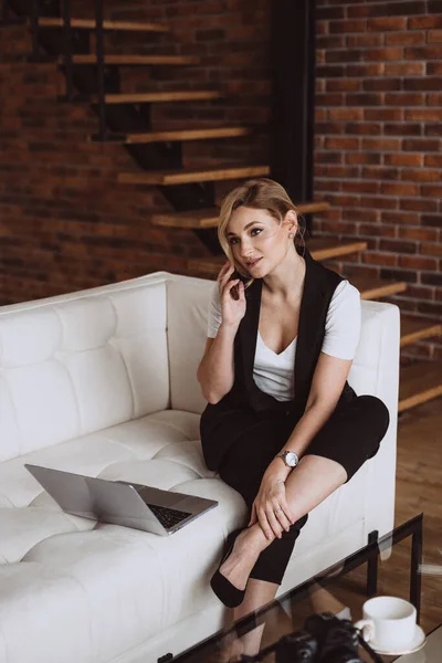 Beautiful business woman decides issues by talking on the phone. Soft selective focus, defocus.