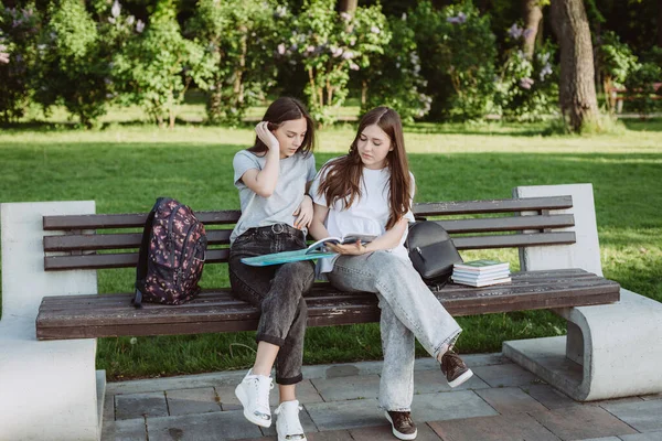 Two Student Girls Looking Open Book Bench Park Distance Education — Stock Photo, Image