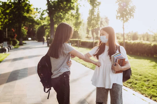 Two Student Girls Protective Medical Masks Greet Elbows Meet Campus — Stock Photo, Image