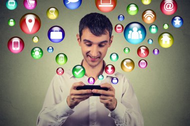 Happy man using texting on smartphone social media application icons flying up