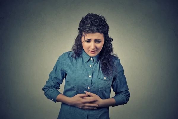Woman hands on stomach having bad aches pain — Stock Photo, Image