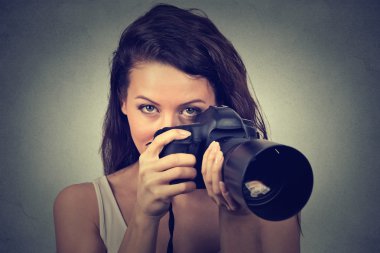 young woman taking pictures with professional dslr camera