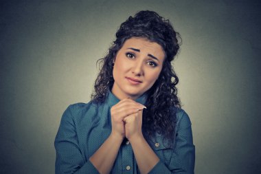 young woman gesturing with clasped hands, please forgive me  clipart